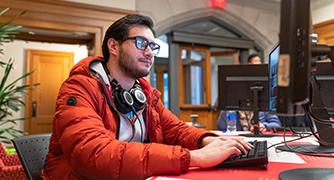 image of student sitting at a computer